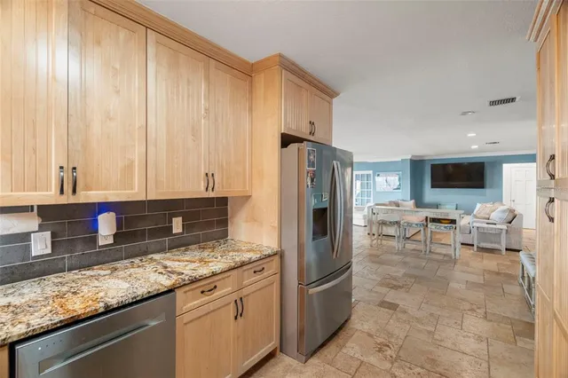 a dining room with furniture a rug and a large window