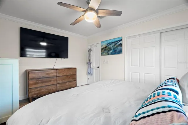 a bedroom with a bed and a painting on the wall