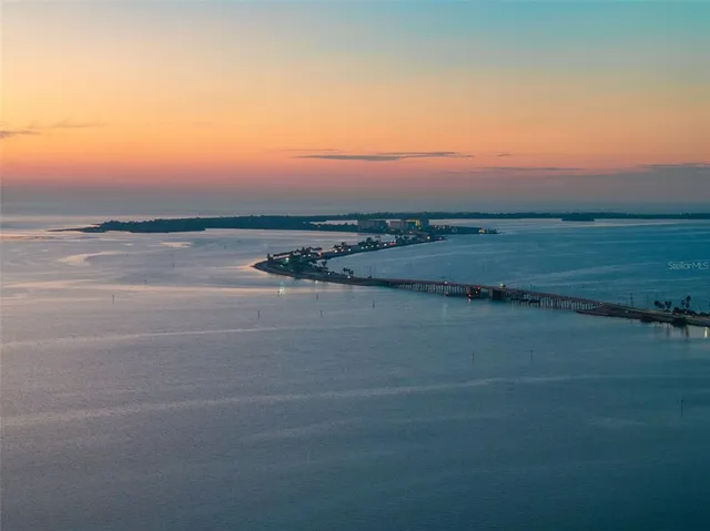 a view of an ocean beach and mountain