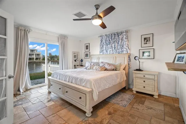 a spacious bedroom with a bed and a cabinets