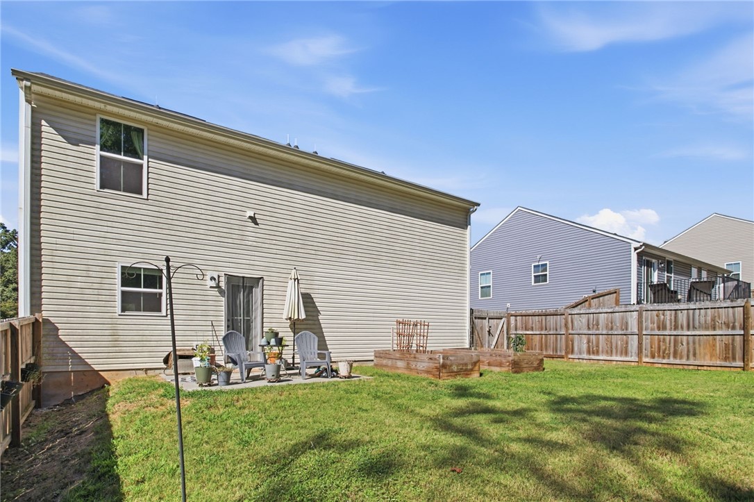 112 Wls Sta Road Seneca, SC 29678 - Photo 37 of 42 A spacious grassy yard is fully enclosed by wooden privacy fencing.
