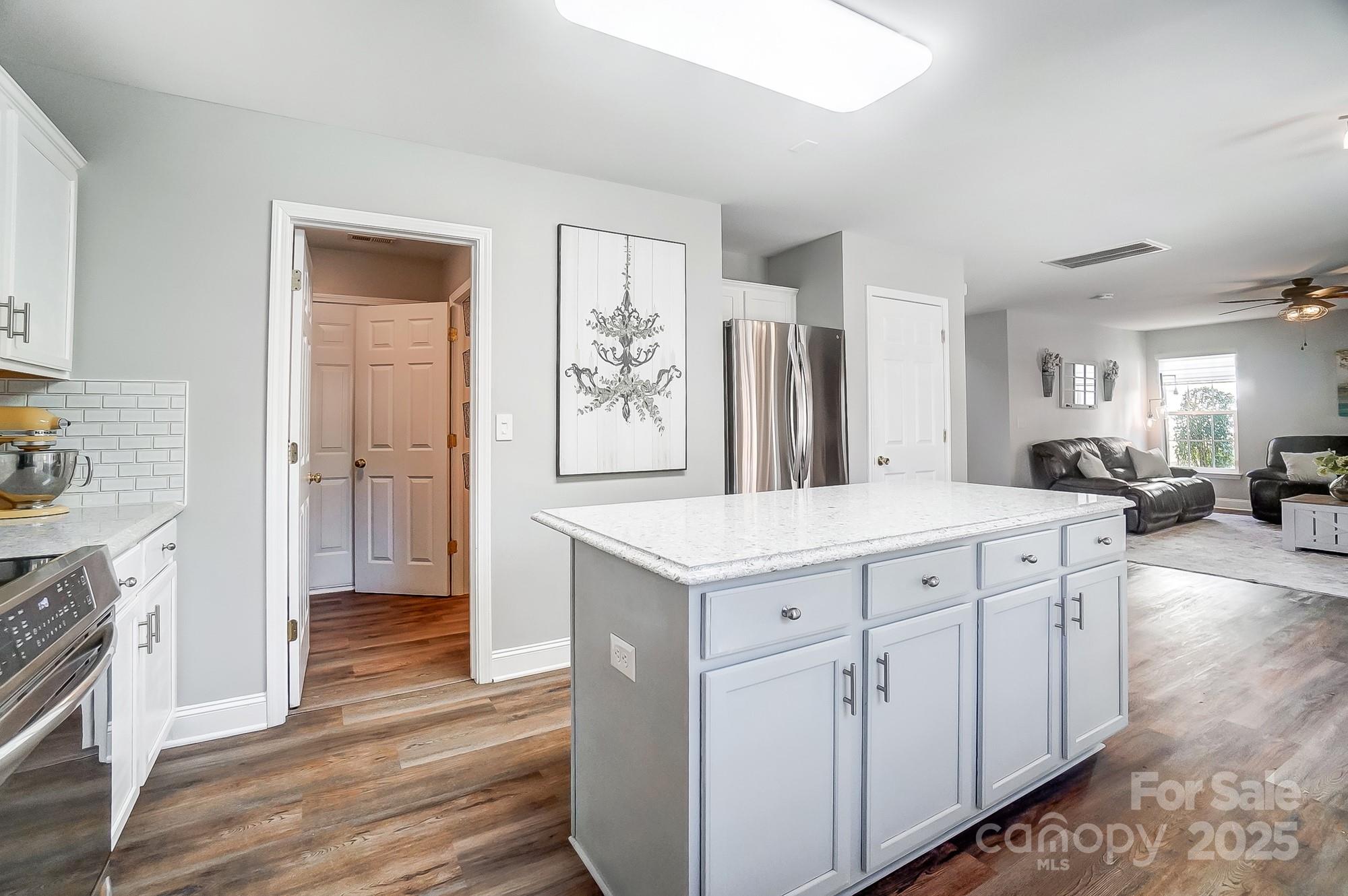 7647 Black Hawk Lane Tega Cay, SC 29708 - Photo 14 of 42 a kitchen with granite countertop a sink and a refrigerator