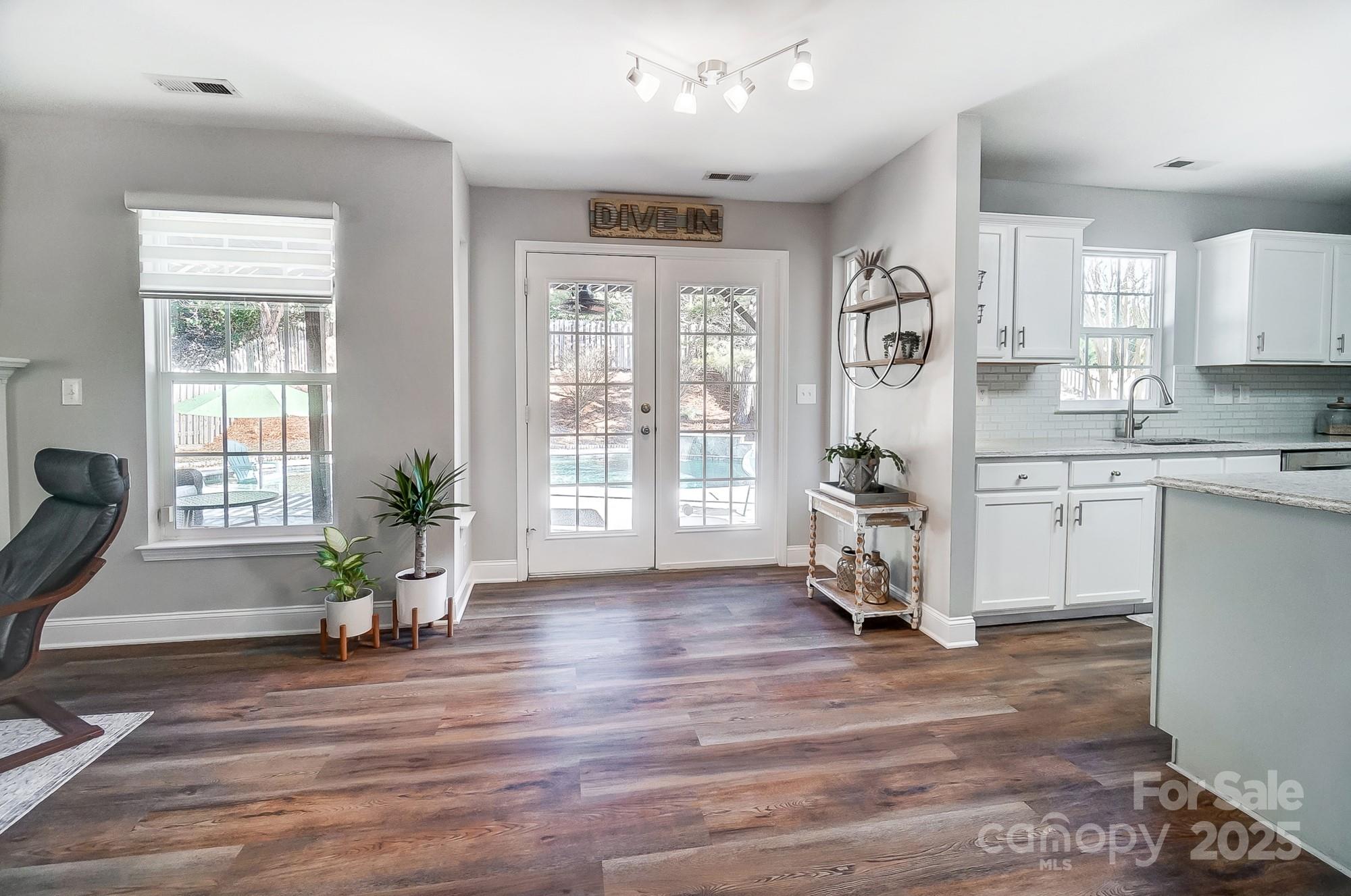 7647 Black Hawk Lane Tega Cay, SC 29708 - Photo 16 of 42 a living room with furniture and a wooden floor