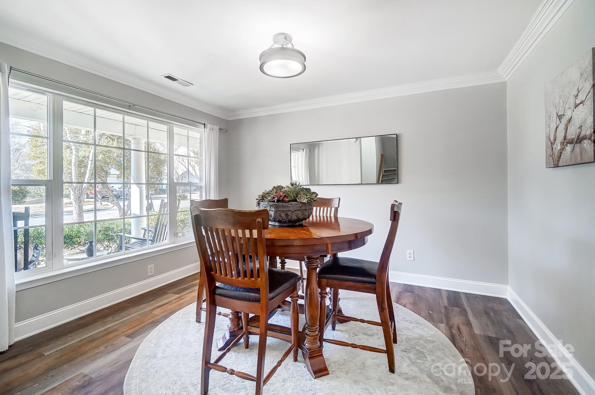 7647 Black Hawk Lane Tega Cay, SC 29708 - Photo 17 of 42 a dining room with furniture and wooden floor