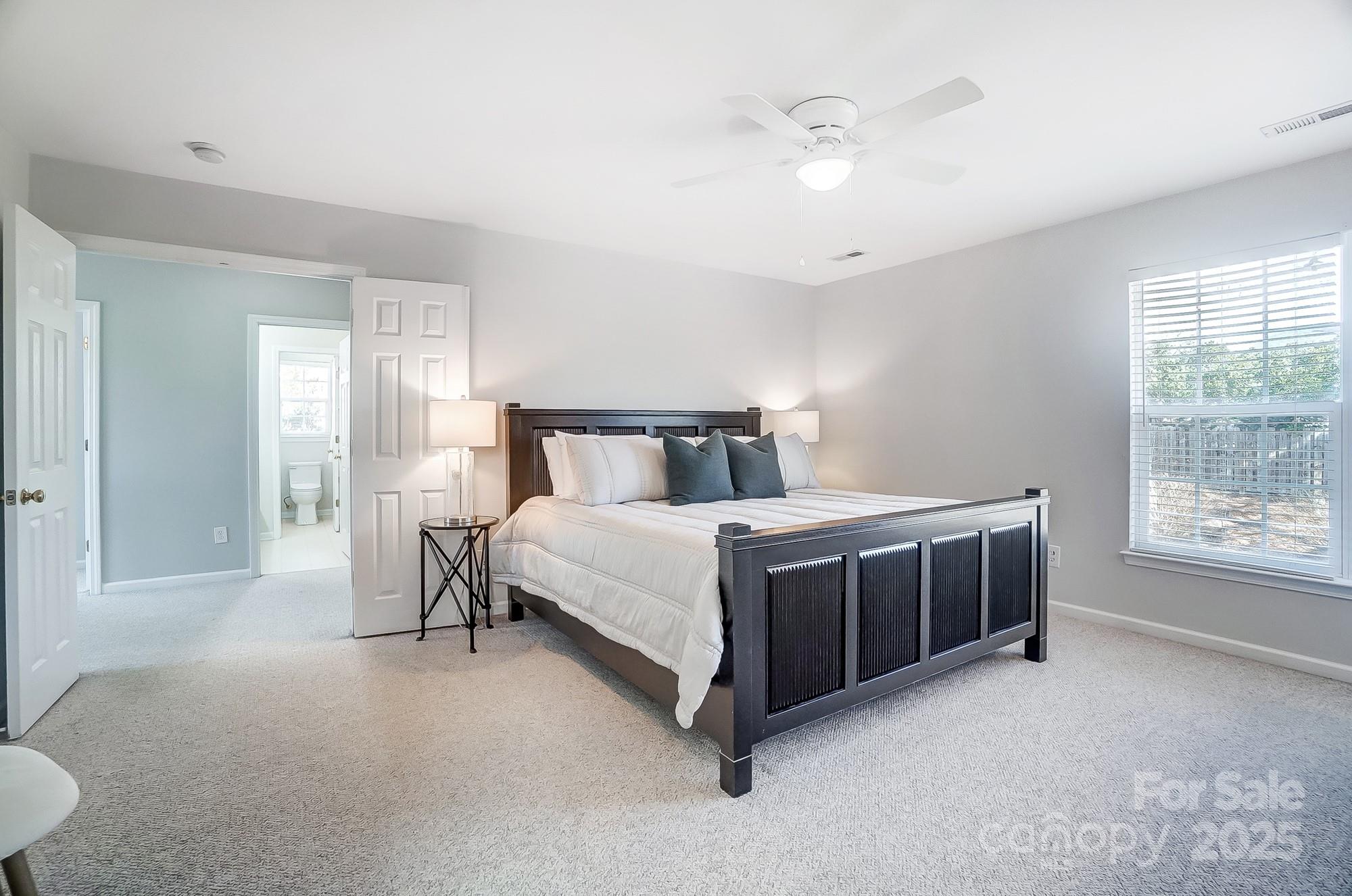 7647 Black Hawk Lane Tega Cay, SC 29708 - Photo 23 of 42 a bedroom with a bed and a chandelier