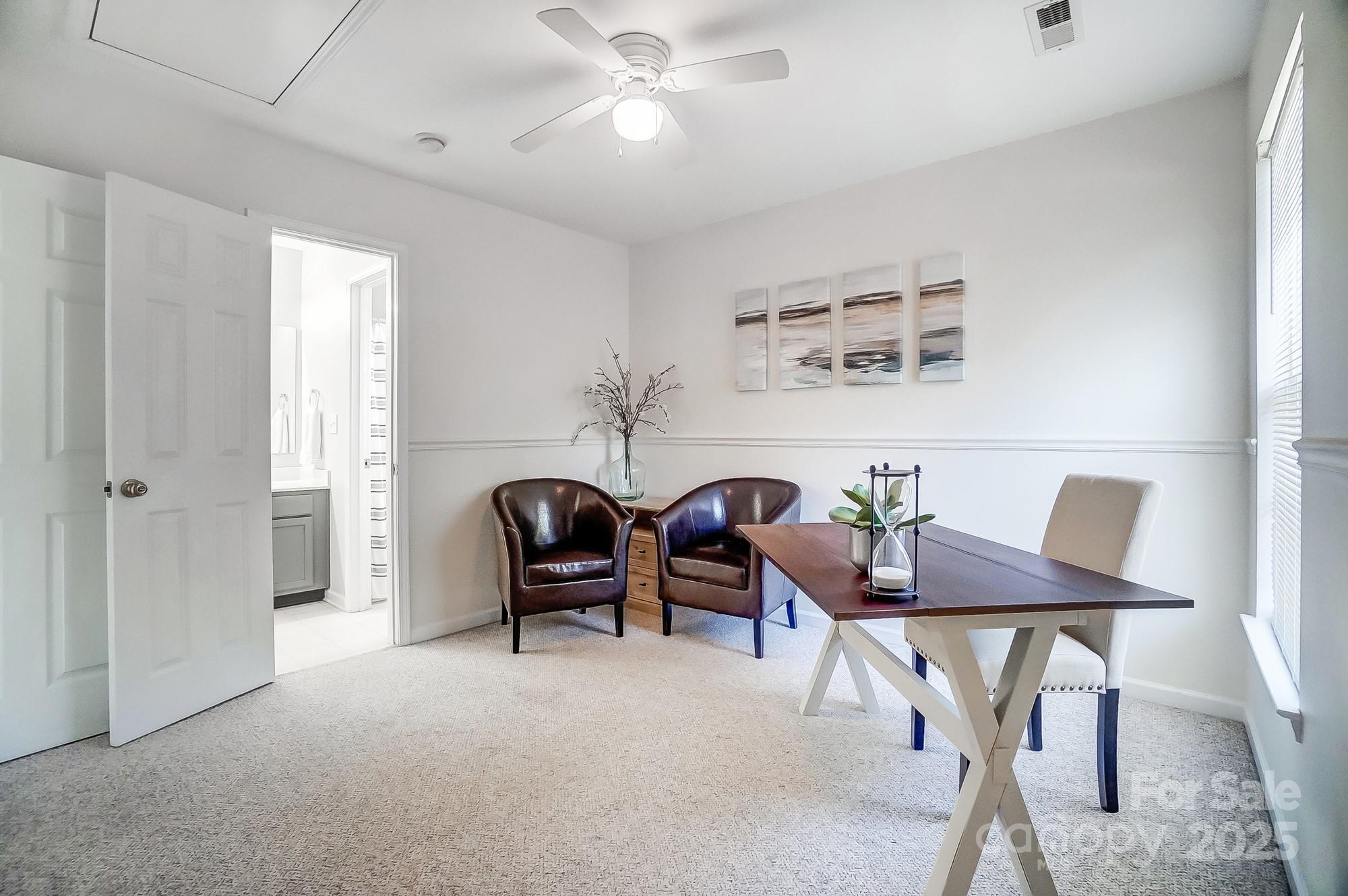 7647 Black Hawk Lane Tega Cay, SC 29708 - Photo 29 of 42 a living room with furniture a ceiling fan and a window