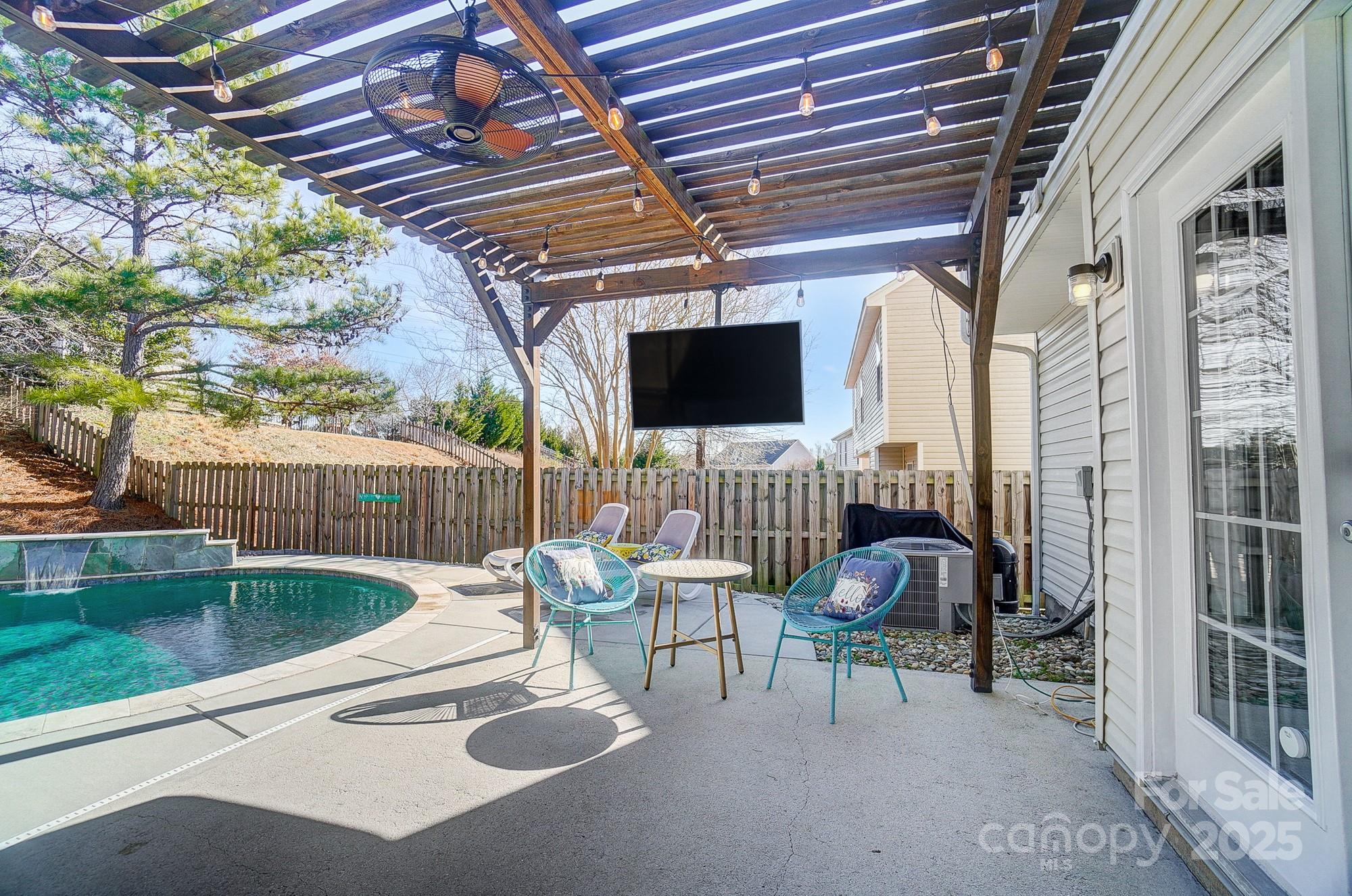 7647 Black Hawk Lane Tega Cay, SC 29708 - Photo 32 of 42 a view of a patio with table and chairs potted plants with wooden floor and fence