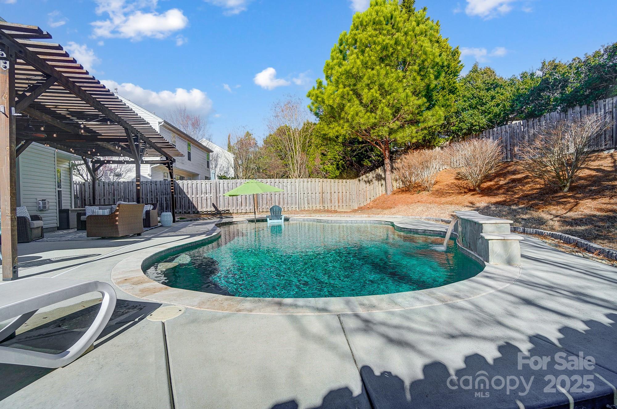 7647 Black Hawk Lane Tega Cay, SC 29708 - Photo 6 of 42 a view of a swimming pool with a patio