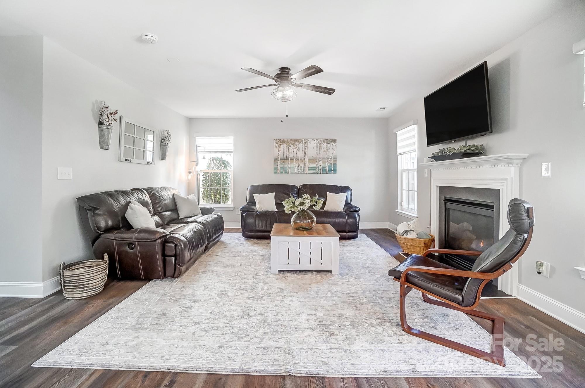 7647 Black Hawk Lane Tega Cay, SC 29708 - Photo 9 of 42 a living room with furniture and a fireplace