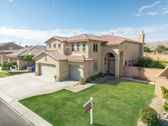 a front view of house with yard and outdoor seating