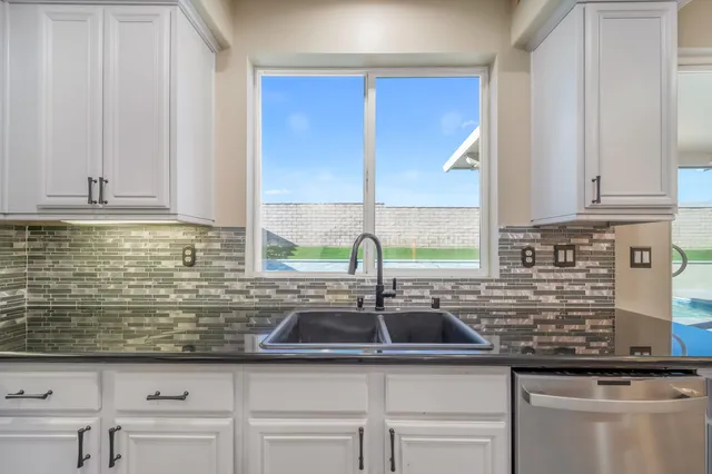 a kitchen with sink cabinets and window