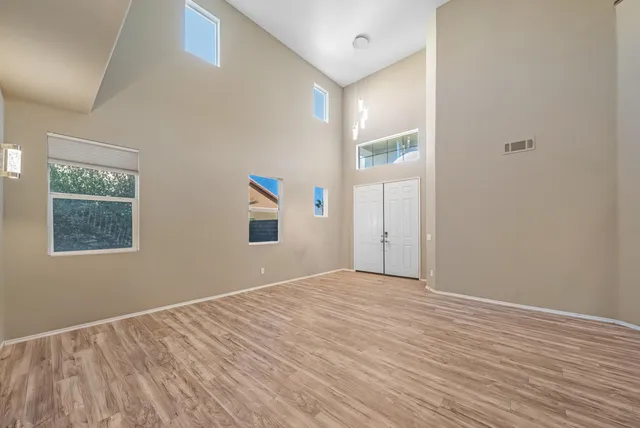 a view of an empty room with wooden floor