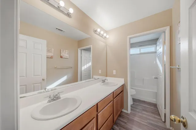 a bathroom with a sink a shower and a mirror