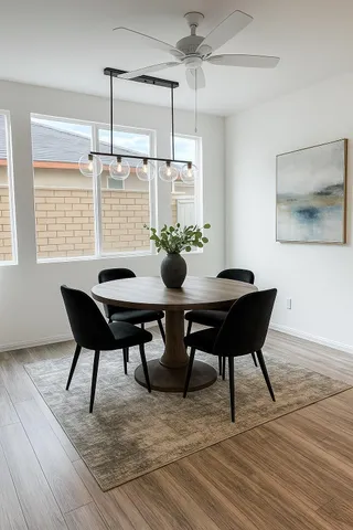 a view of a dining room with furniture window and wooden floor