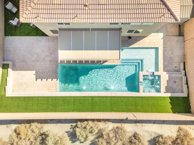 a view of a house with a yard and potted plant