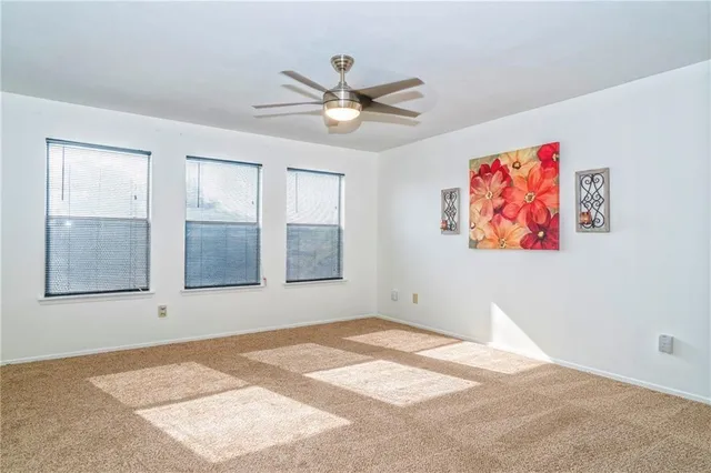 an empty room with a bathroom and mirror