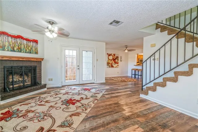 a view of an empty room with window and fireplace