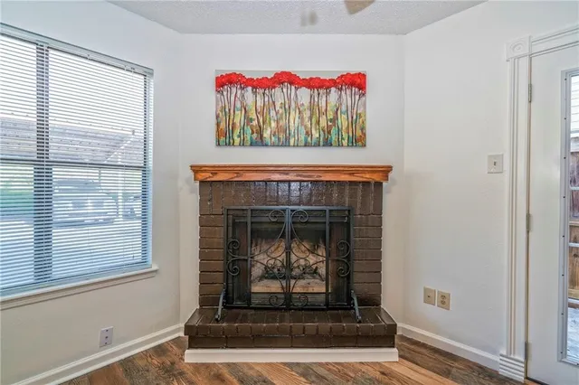 a living room with a fireplace and a window