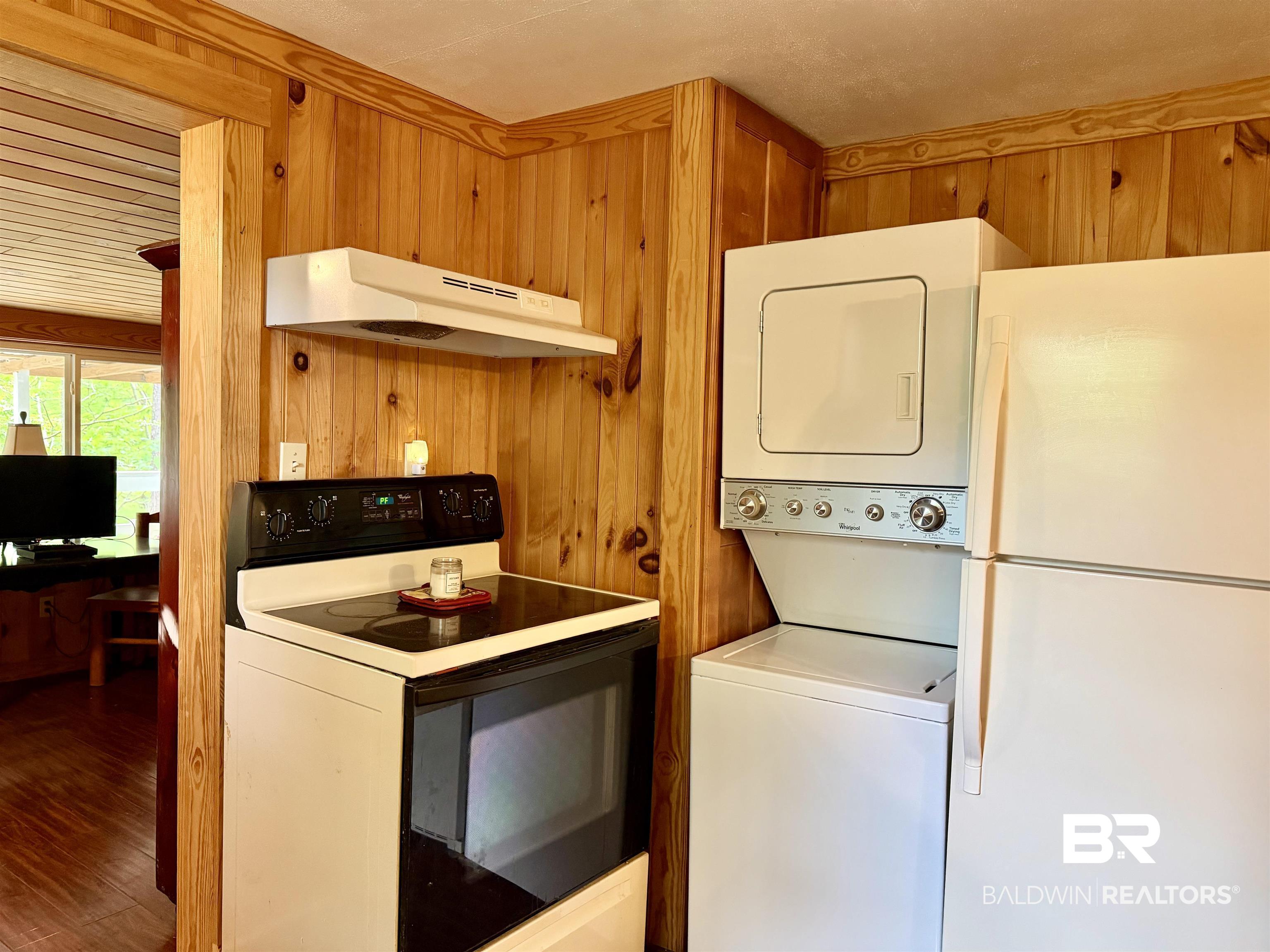 762 Buddy Lake Road Brewton, AL 36426 - Photo 9 of 20 Kitchen area featuring wood-paneled walls and integrated appliances