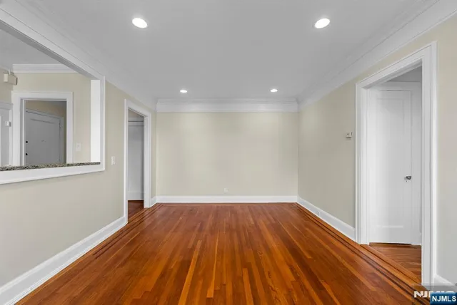 a view of a room with wooden floor