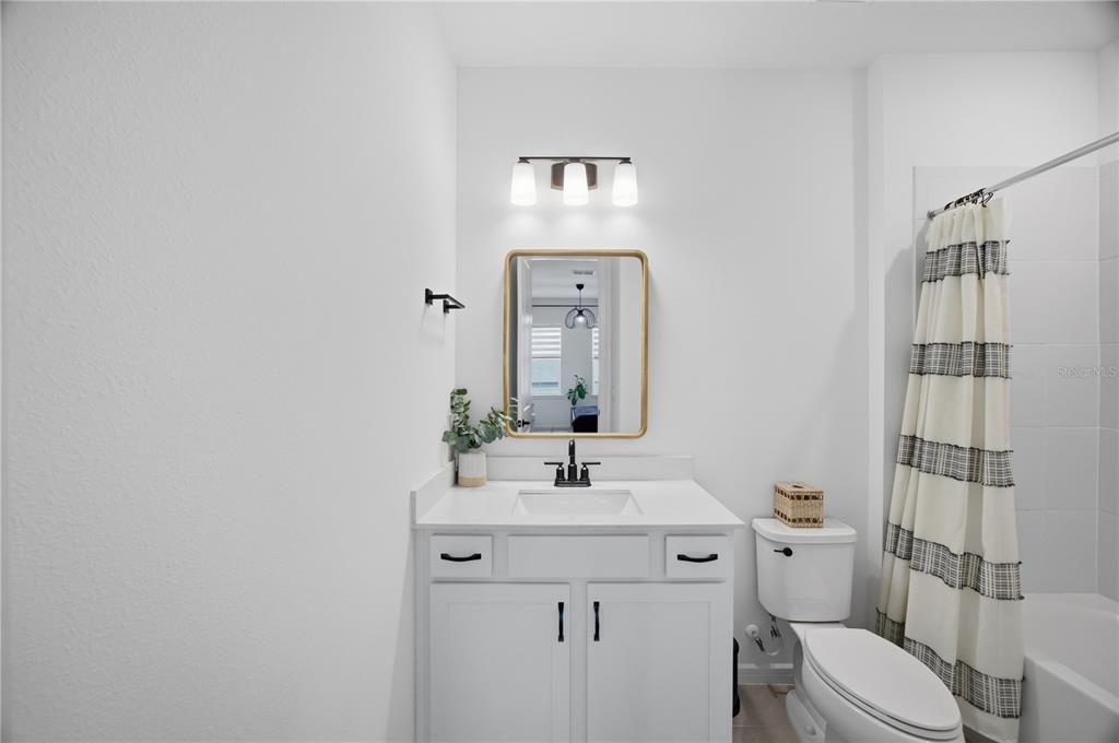 13816 Sharp Hawk Drive Riverview, FL 33569 - Photo 46 of 76 a bathroom with a toilet sink and mirror