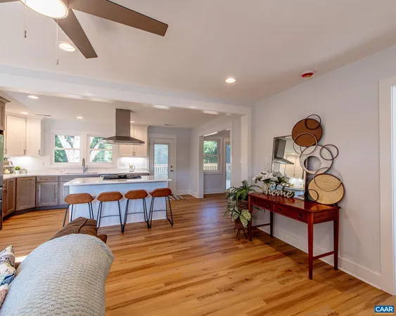 a kitchen with stainless steel appliances granite countertop table chairs refrigerator and sink