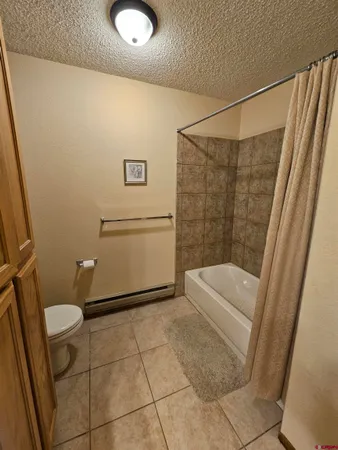 a bathroom with a granite countertop sink and a tub
