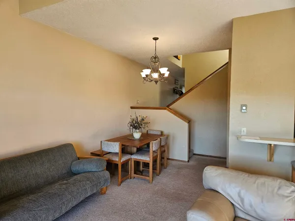 a living room with a bed furniture and a window