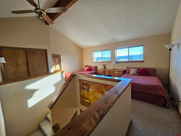a bedroom with a bed and a mirror