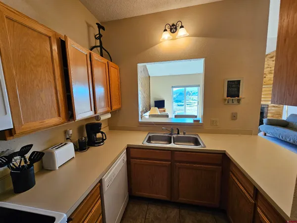 a kitchen with a stove top oven a sink and a refrigerator