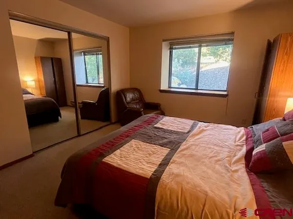 a bedroom with a bed and window