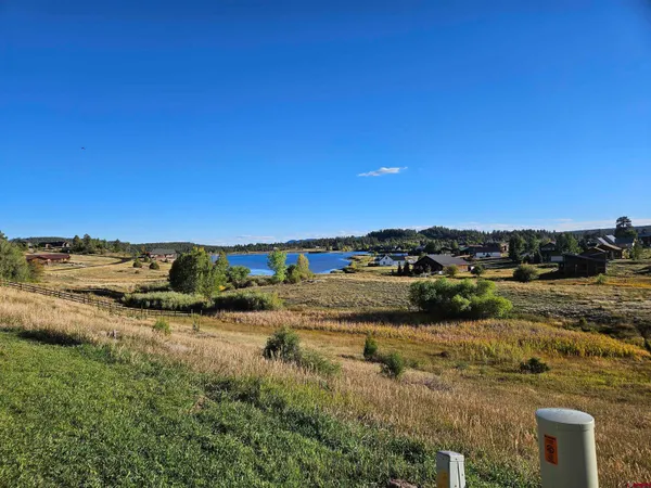 a view of a lake with houses in the back