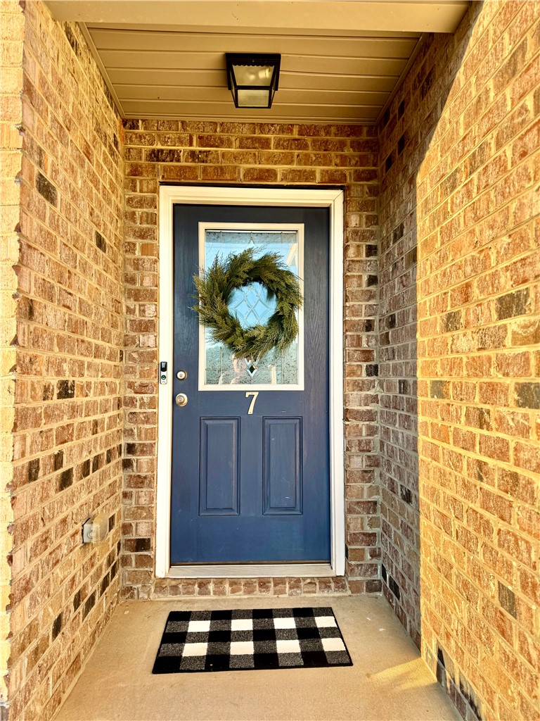 7 Ravencrest Drive Anderson, SC 29621 - Photo 11 of 43 The welcoming entryway boasts a vibrant door and classic brickwork, creating an inviting first impression.