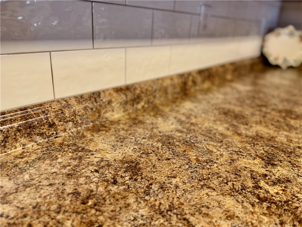 7 Ravencrest Drive Anderson, SC 29621 - Photo 14 of 43 This kitchen showcases durable countertops and a stylish tile backsplash.