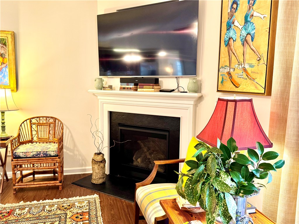 7 Ravencrest Drive Anderson, SC 29621 - Photo 20 of 43 This inviting living space features rich hardwood flooring and a classic fireplace, perfect for cozy gatherings.