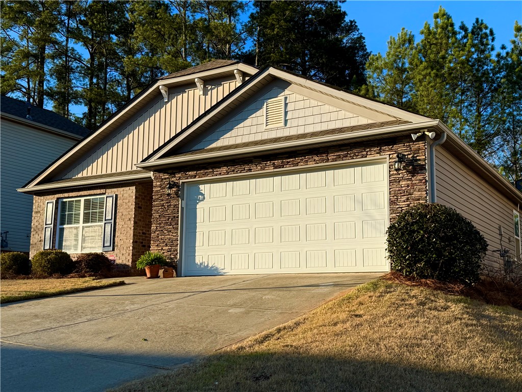 7 Ravencrest Drive Anderson, SC 29621 - Photo 3 of 43 This charming home features a mix of brick and siding, a concrete driveway, and an attached garage.