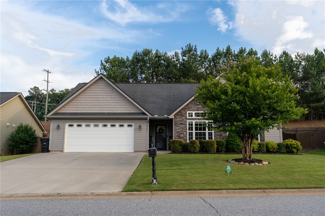 1012 Whirlaway Circle Anderson, SC 29621 - Photo 1 of 25 A welcoming facade features a well-kept lawn, concrete driveway, and a sturdy garage door.