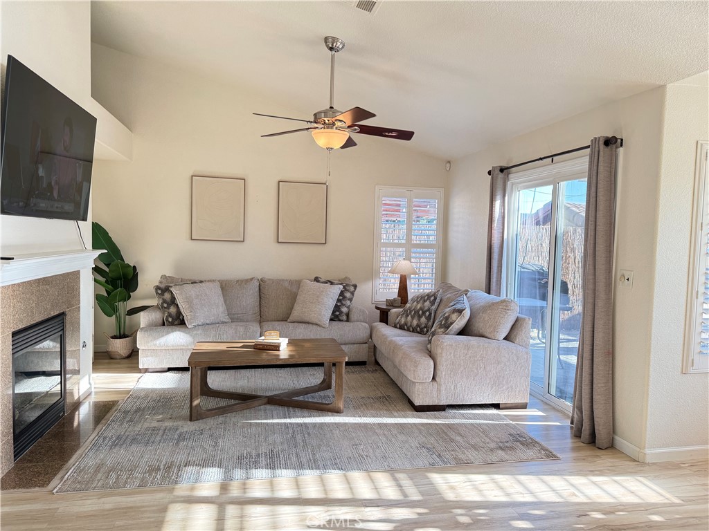 2709 Big Sandy Avenue Merced, CA 95348 - Photo 20 of 51 a living room with furniture a fireplace and a flat screen tv
