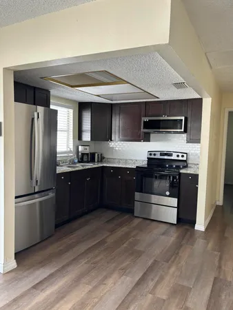 a kitchen with stainless steel appliances and granite countertop
