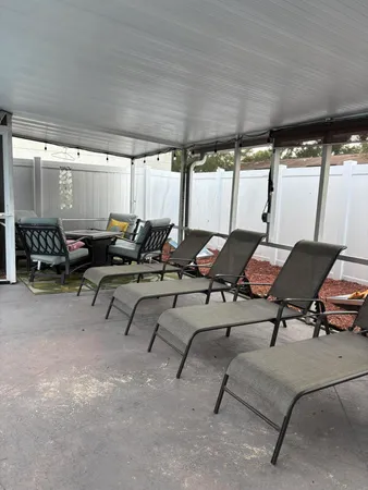 a view of a swimming pool with a porch and furniture