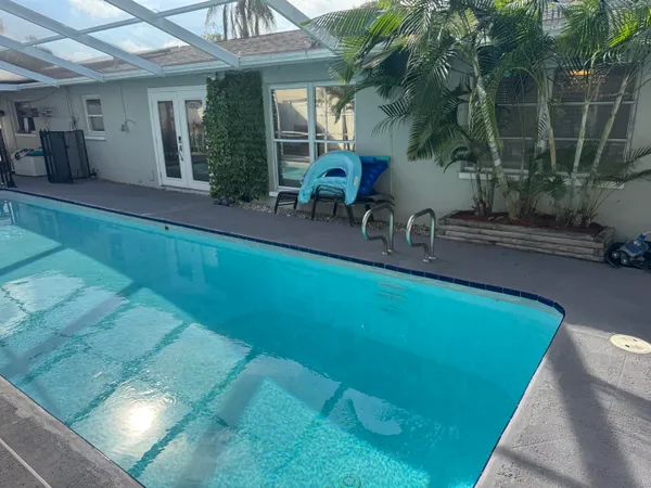 swimming pool view with a garden space