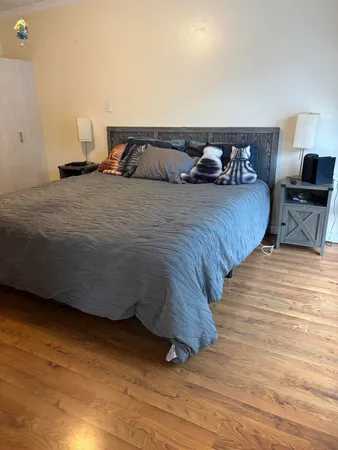 a bedroom with a bed and a lamp on table
