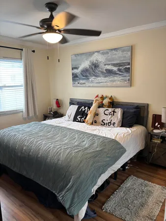 a bedroom with a bed and a painting on the wall