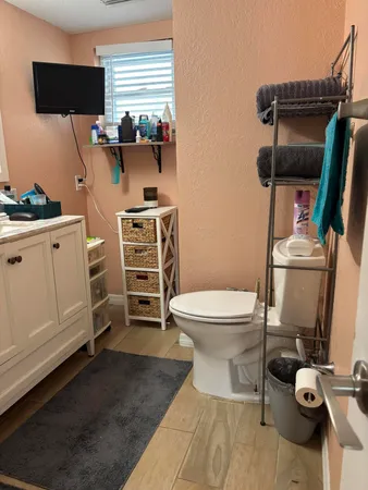 a bathroom with a toilet sink and mirror
