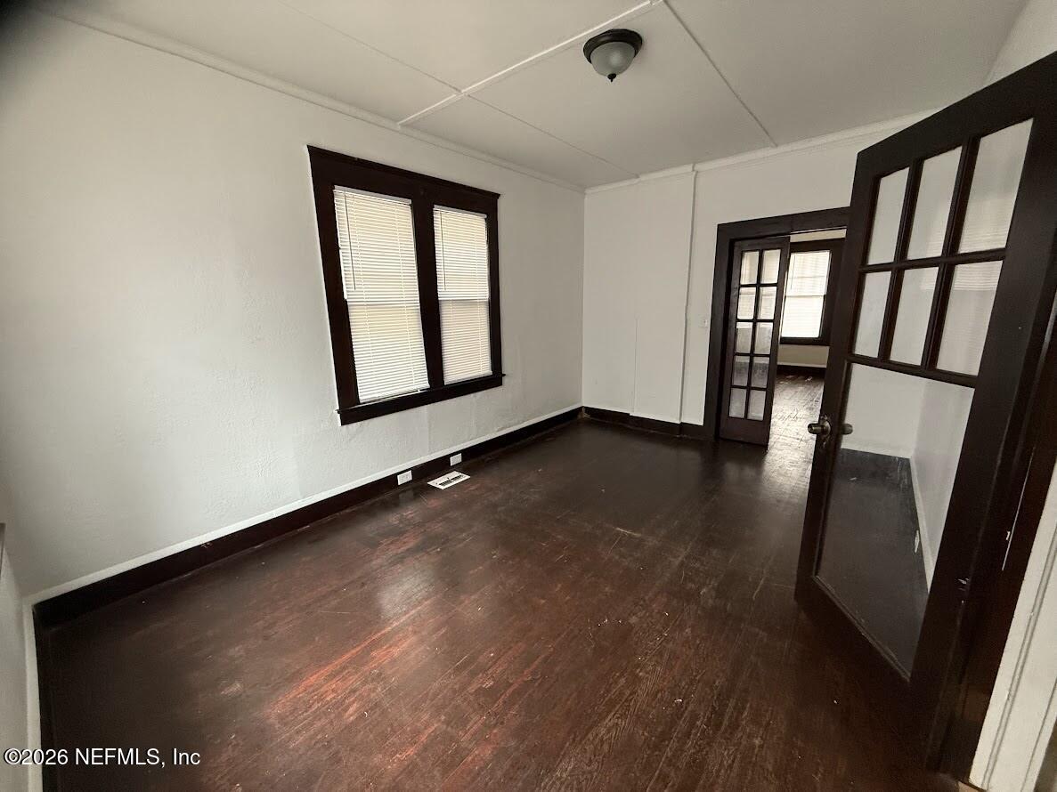 2036 Moncrief Road Jacksonville, FL 32209 - Photo 5 of 32 an empty room with wooden floor and windows