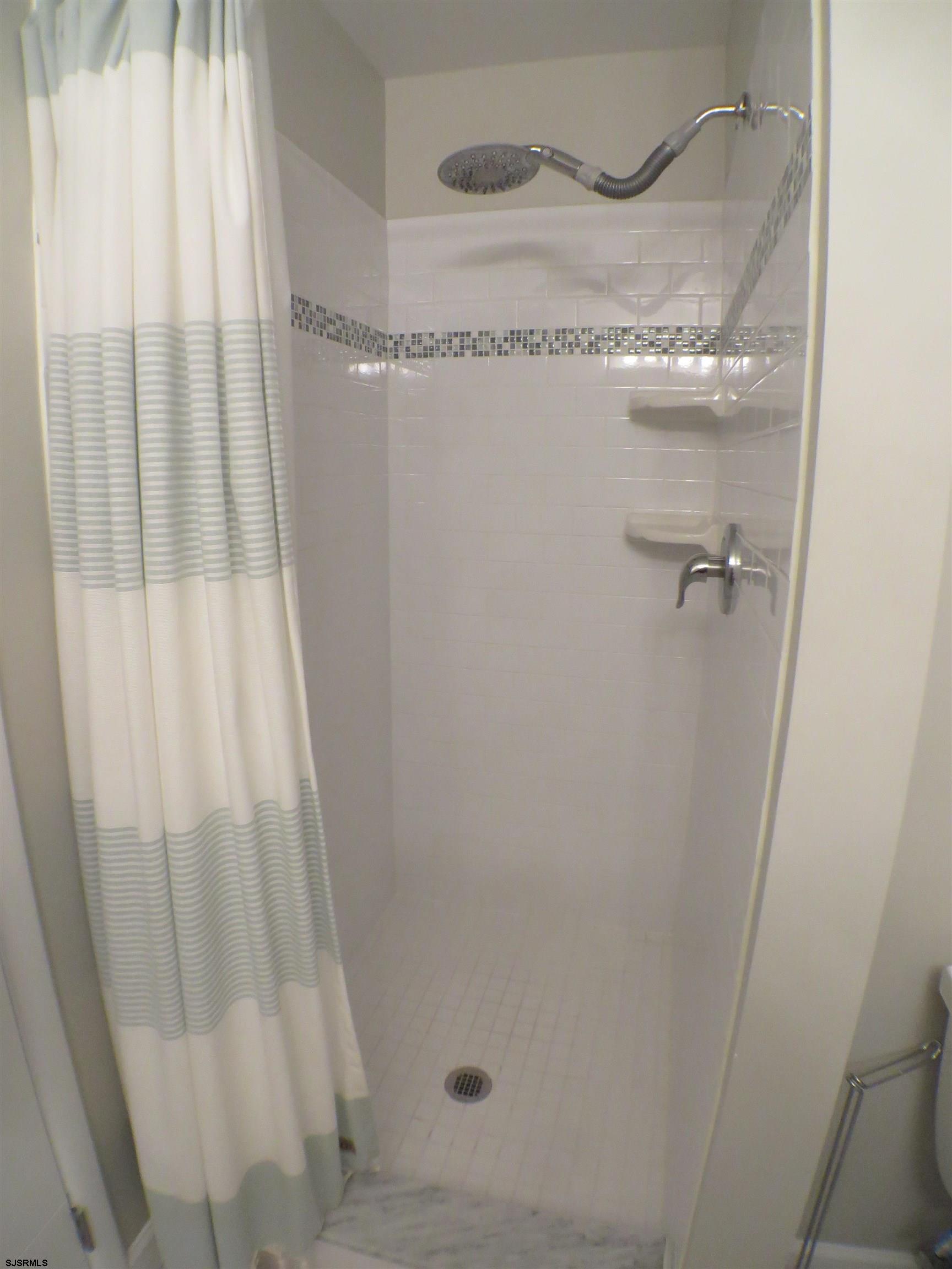 210 Simpson Avenue, Unit 2 Ocean City, NJ 08226 - Photo 15 of 20 a bathroom with a granite countertop sink and vanity