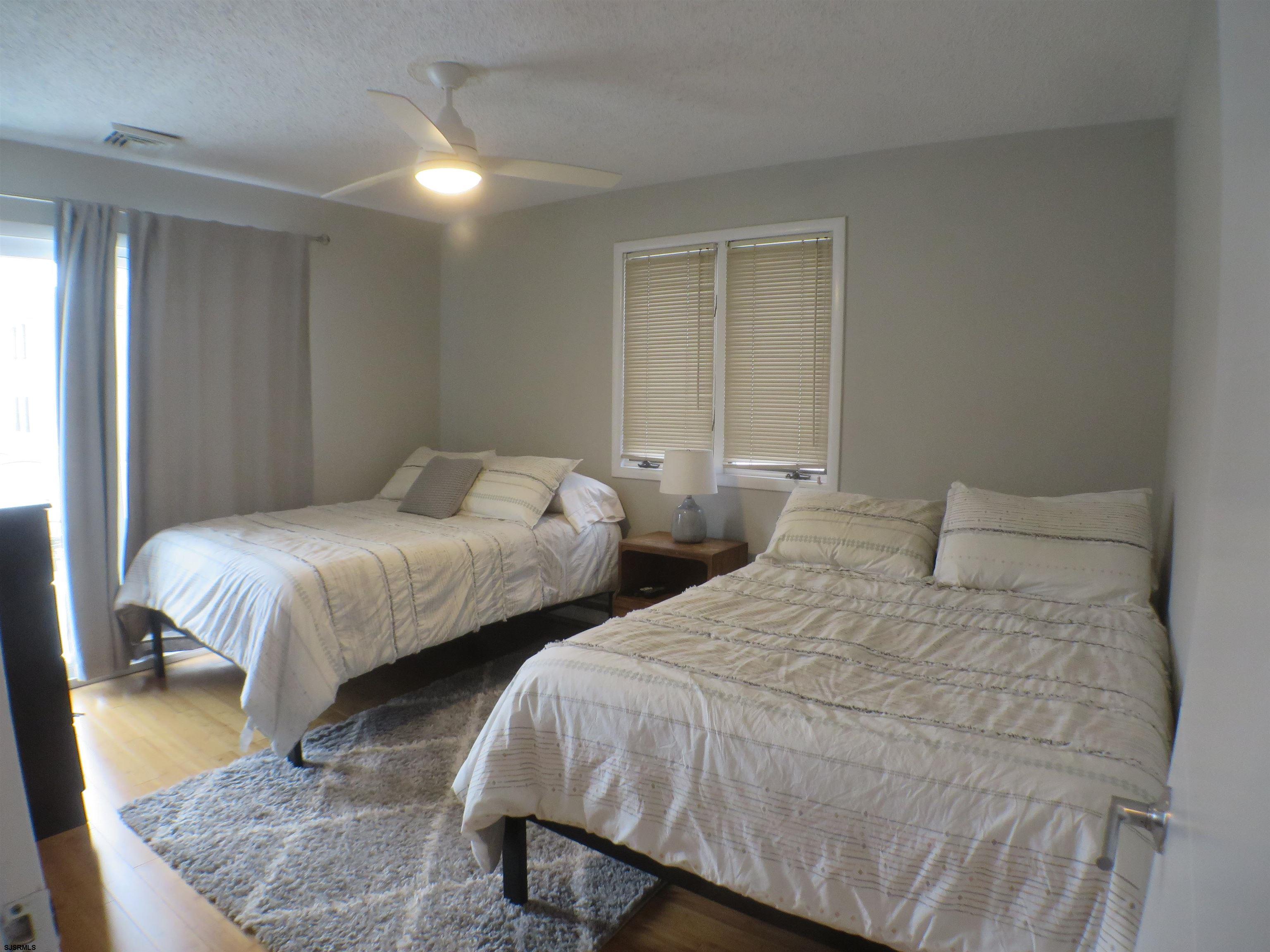 210 Simpson Avenue, Unit 2 Ocean City, NJ 08226 - Photo 16 of 20 a bedroom with two beds and painting on the wall