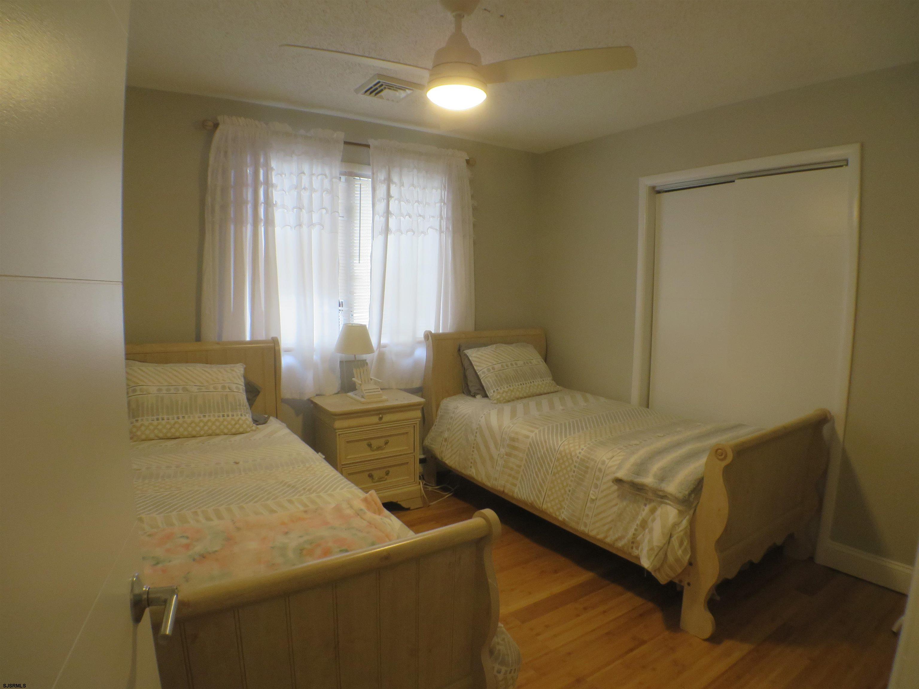 210 Simpson Avenue, Unit 2 Ocean City, NJ 08226 - Photo 18 of 20 a bedroom with a bed and window