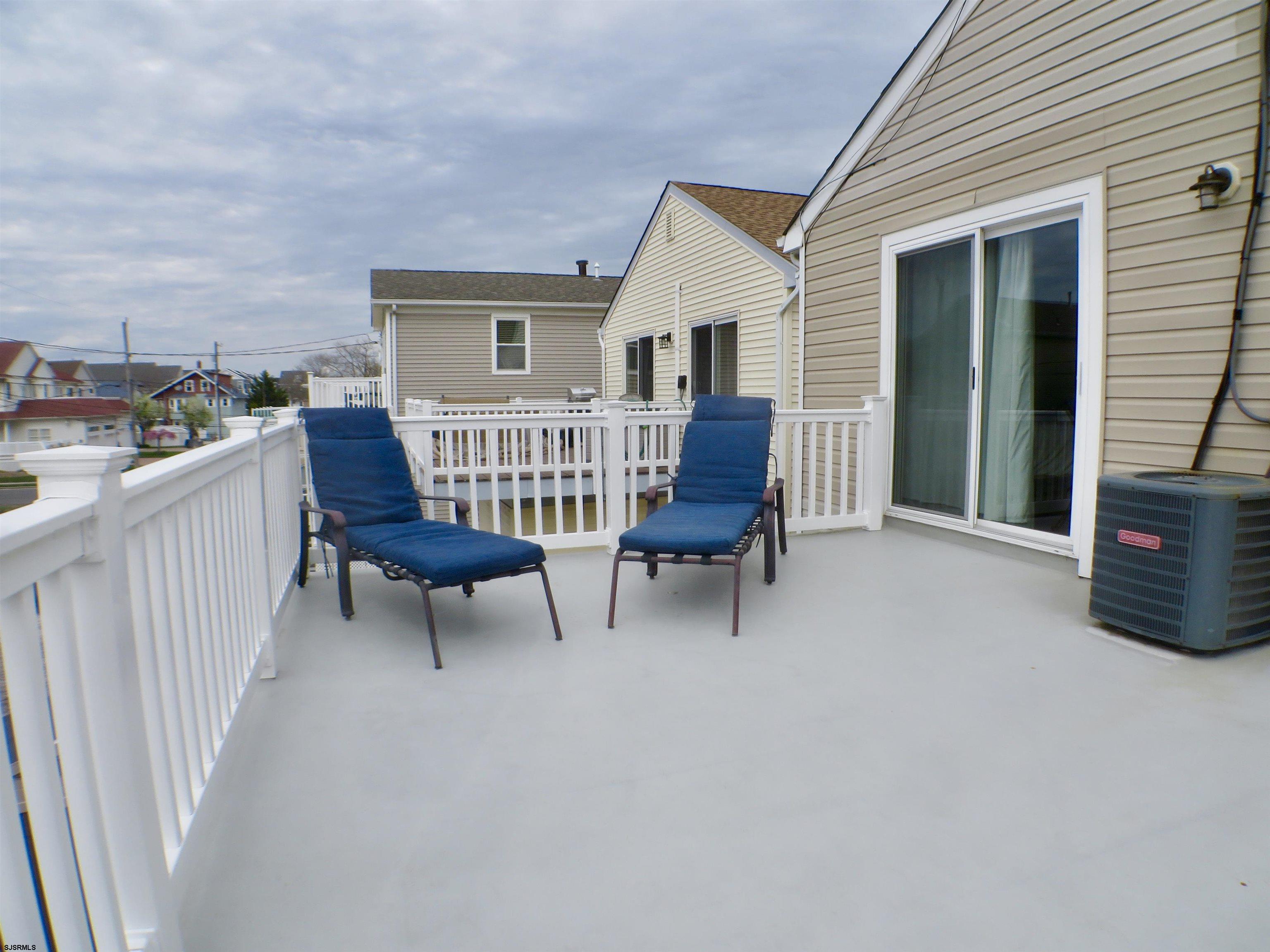 210 Simpson Avenue, Unit 2 Ocean City, NJ 08226 - Photo 19 of 20 a view of a house with porch and wooden bench