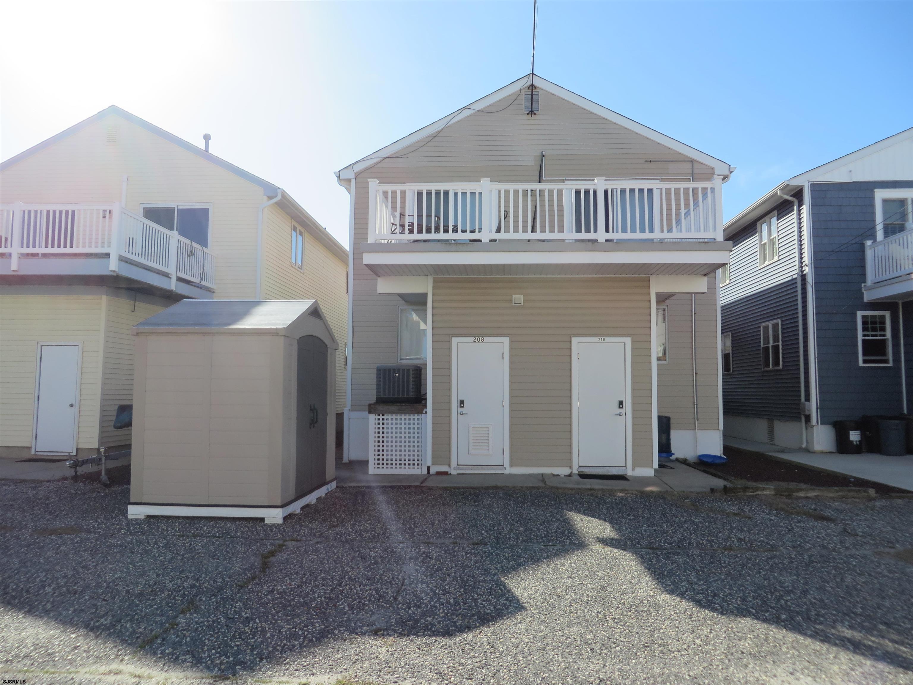 210 Simpson Avenue, Unit 2 Ocean City, NJ 08226 - Photo 20 of 20 a front view of a house with a yard